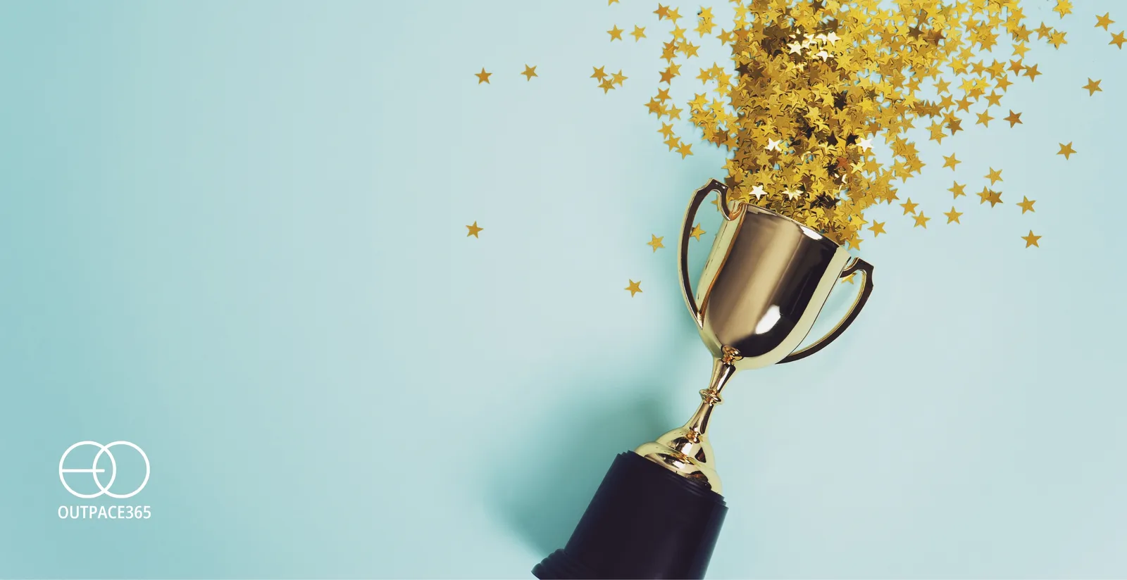 A gold trophy showered in confetti against a mint background