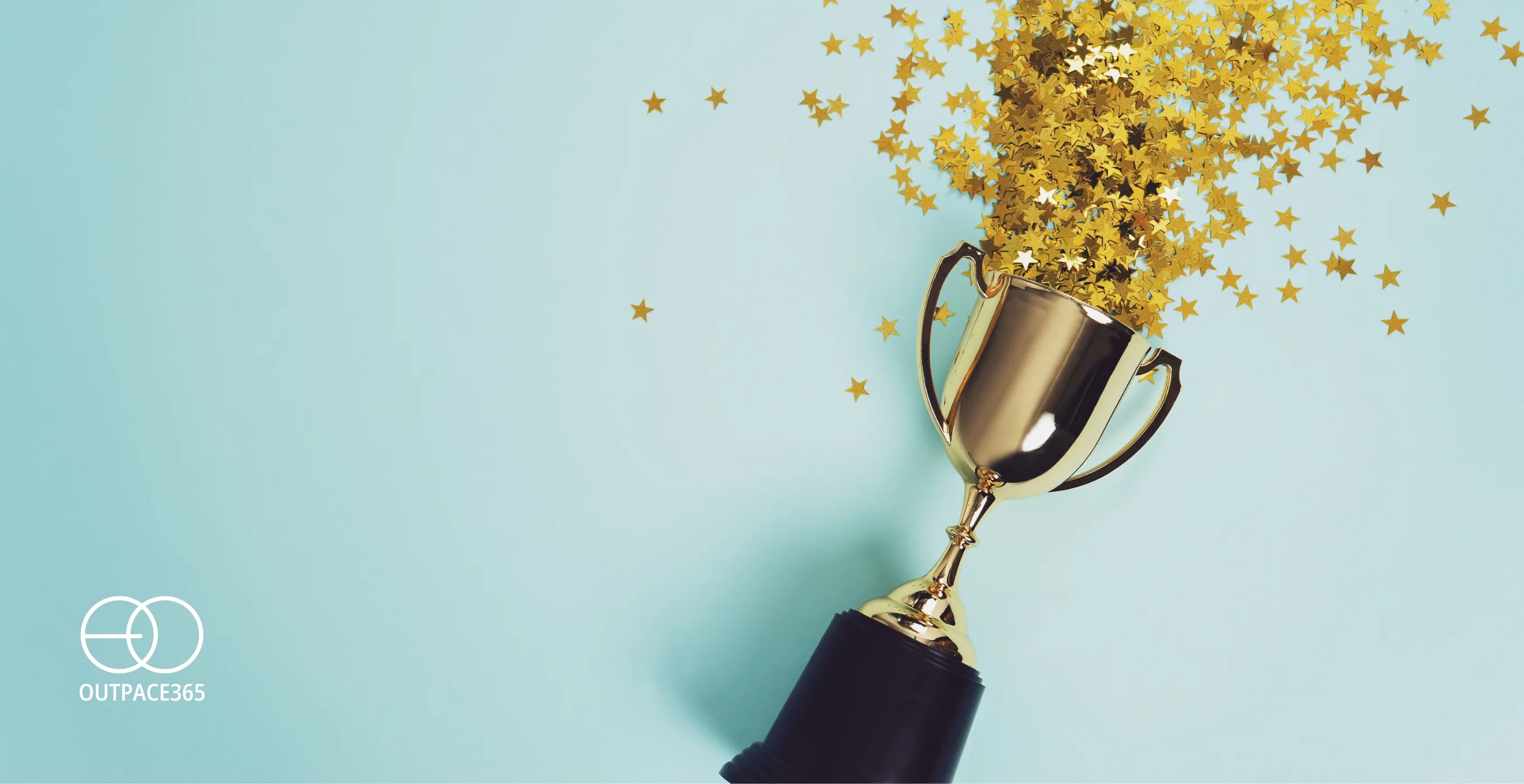 A gold trophy showered in confetti against a mint background