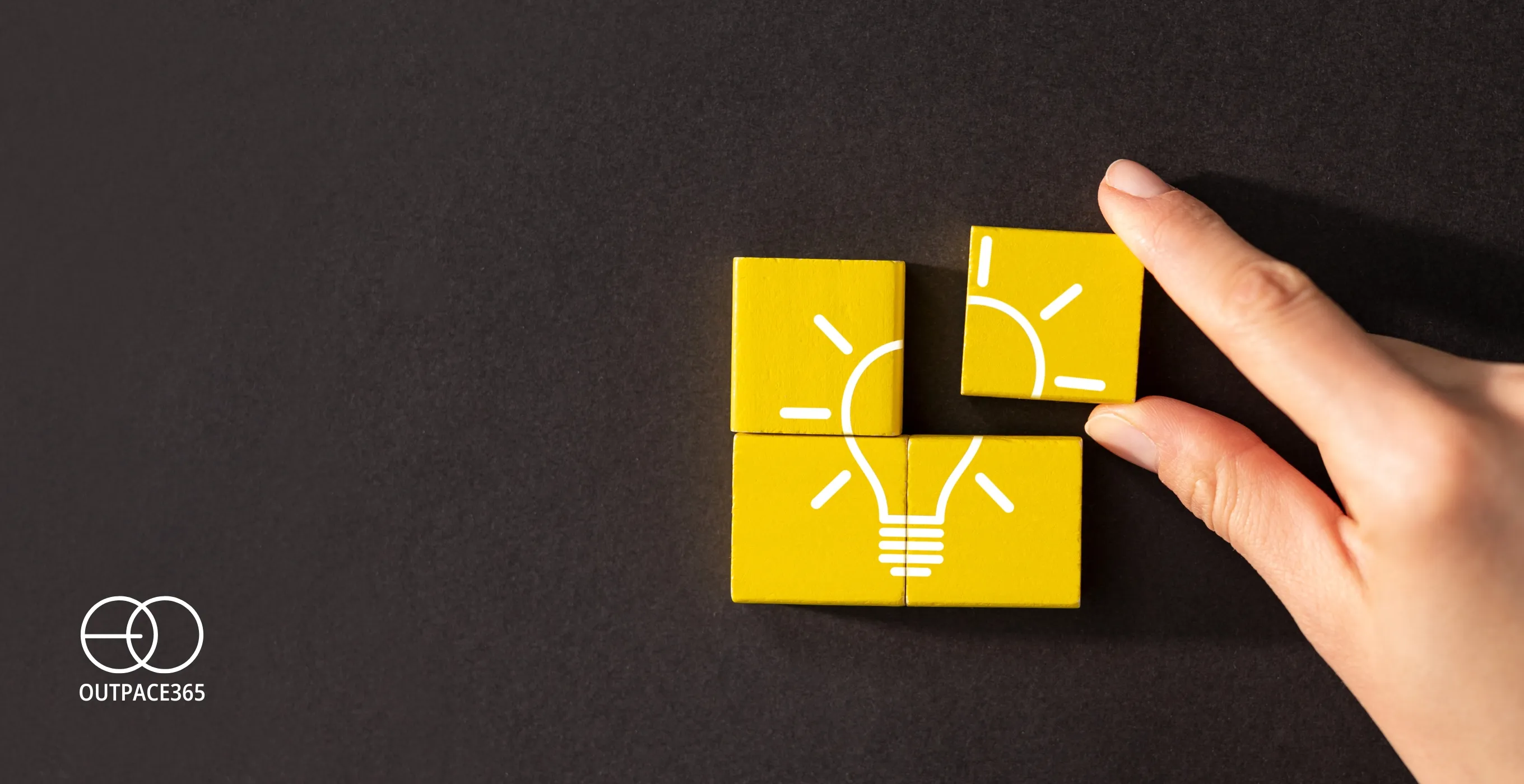 A hand placing the last yellow tile to complete a lightbulb puzzle