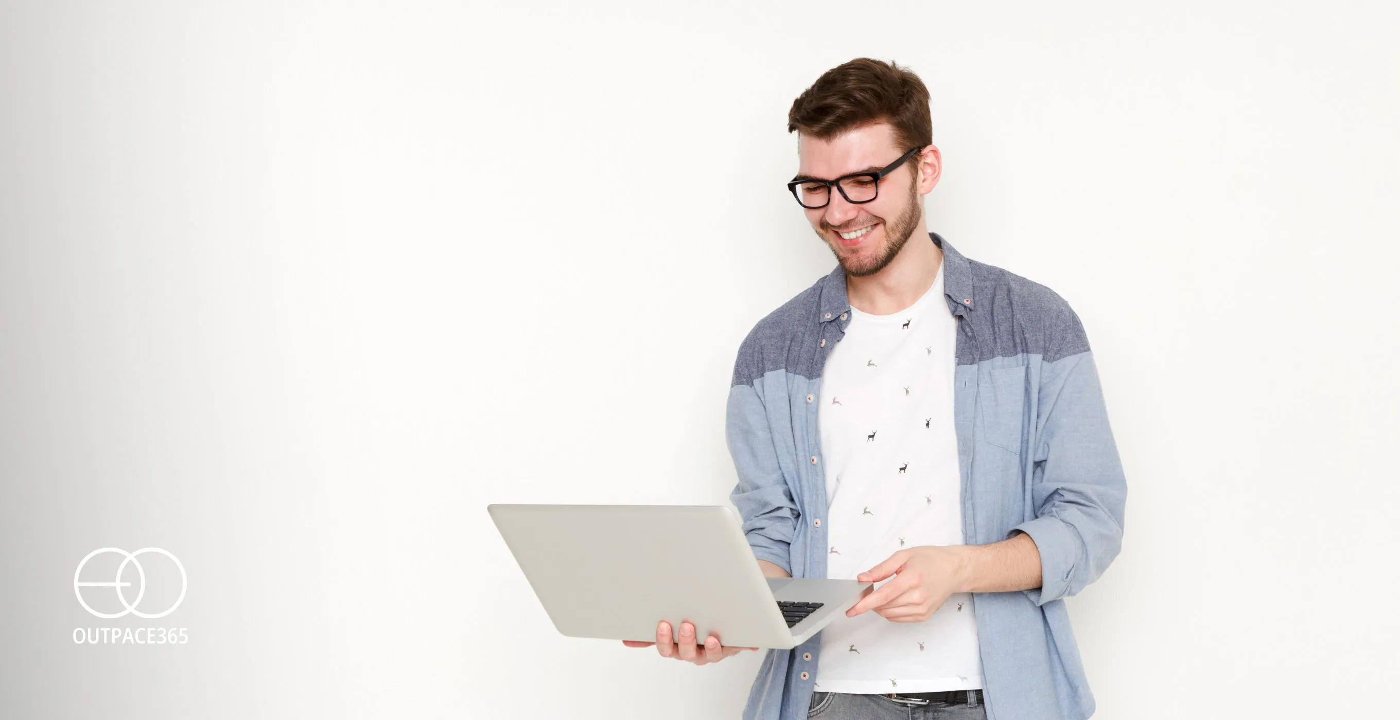 A man in glasses holding an open laptop against a white background