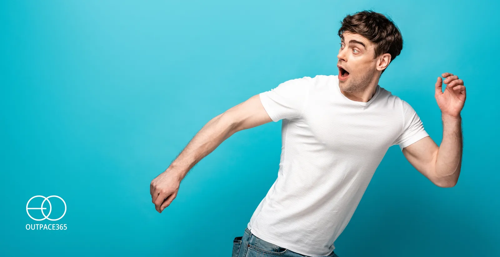 A man mid-stride, turning away against a turquoise background
